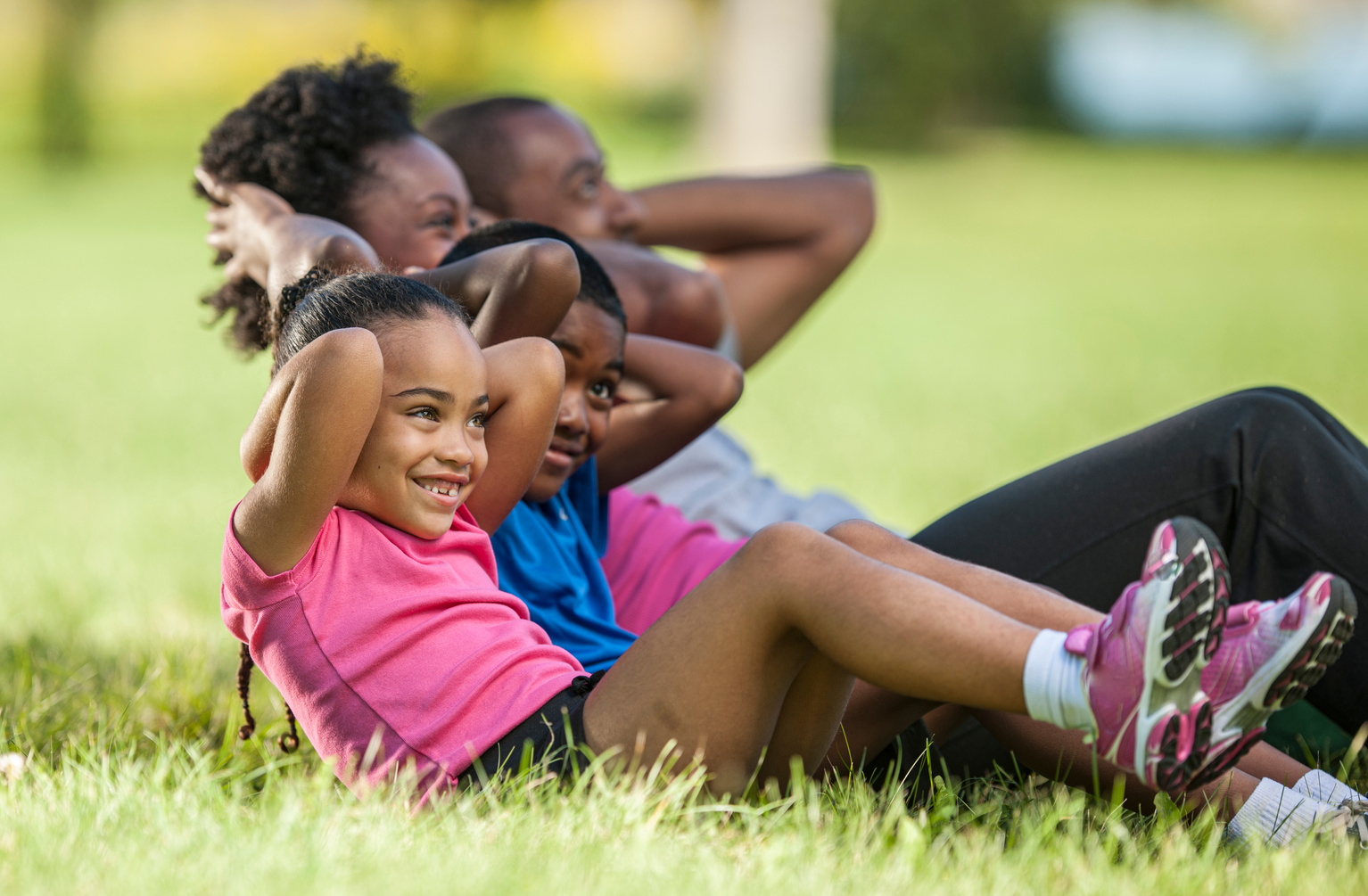 Family of 4 staying fit outside together